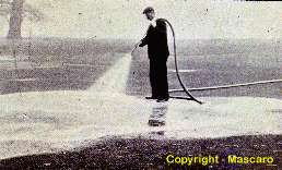 Application of "worm eradicating fertilizer to golf green".  1920's.