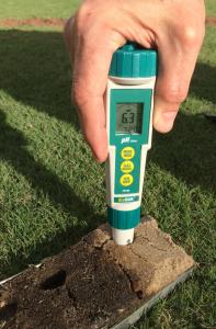Direct Soil pH Pen being used with the Mascaro Profile Sampler showing a reading of 6.80 in the roots zone about three inches deep