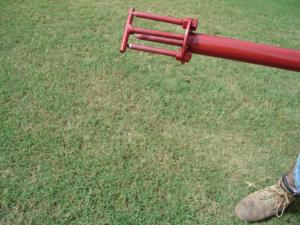 Push down spring loaded ejection rod on the Turf-Tec WeedAway to remove weed from tool