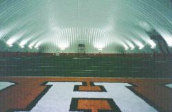 Southwest Texas University in San Marcos, TX also had an indoor practice field in an inflatable dome.  The surface is artificial turf (Astro Play) with two inches of crumb rubber topdressing mixed in with the fibers.