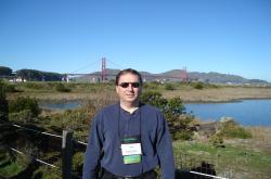 This is John Mascaro standing in a park with the Golden Gate bridge in the background.