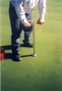 Insert Duich Ball Mark Plugger into soil until depth gauge