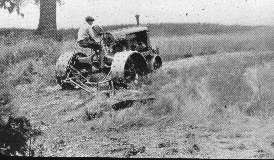 Tractor with Sickle Bar Mower attachment for mowing rough.