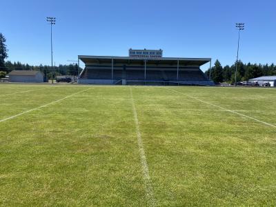 Before painting - worn and faded paint lines on athletic field are barely visible